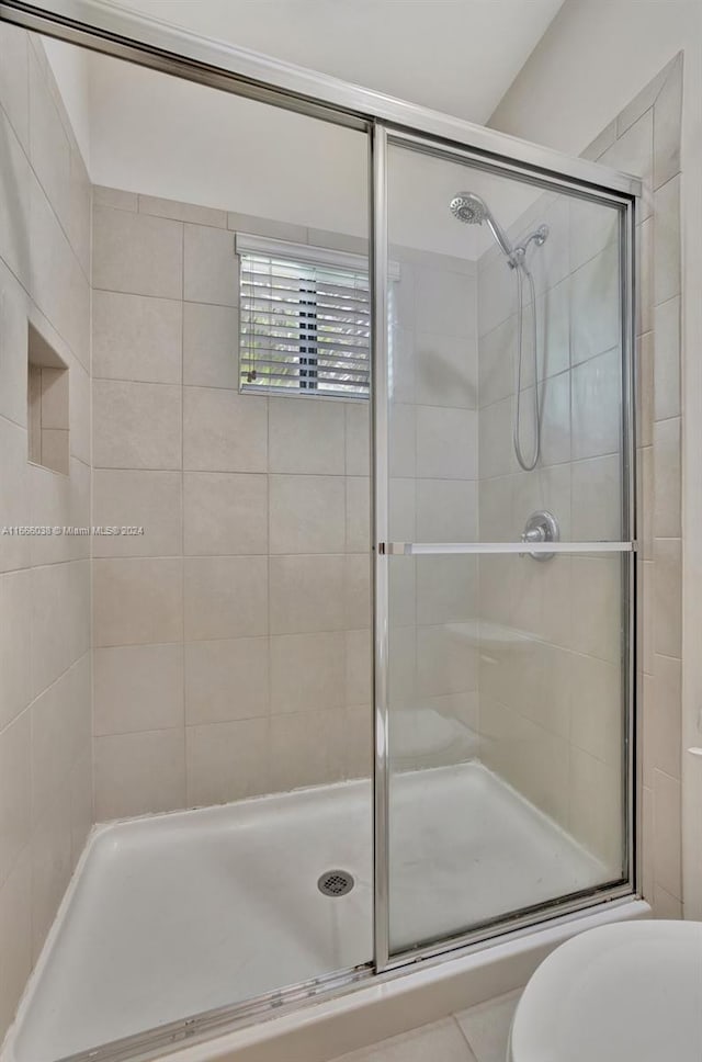 bathroom with walk in shower and toilet