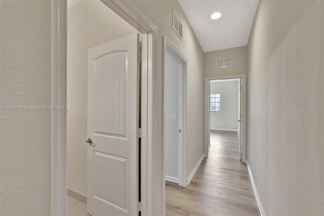 corridor featuring light hardwood / wood-style floors