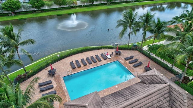 view of swimming pool with a water view and a patio area