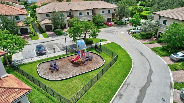 exterior space featuring a playground and a yard