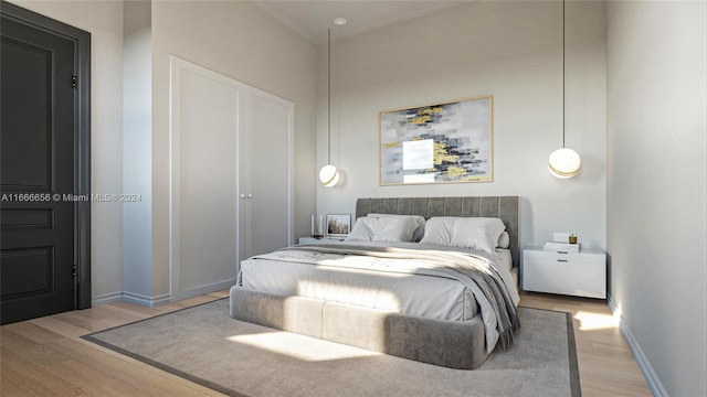 bedroom featuring ornamental molding and light wood-type flooring