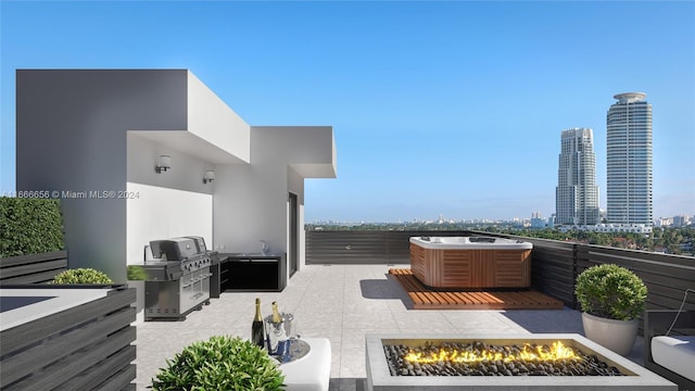 view of patio / terrace with exterior kitchen and a fire pit