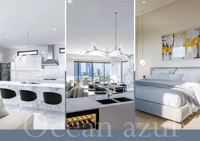 interior space featuring stainless steel fridge, light hardwood / wood-style floors, sink, and a chandelier