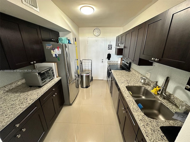 kitchen featuring electric stove, dark brown cabinets, light stone counters, and sink