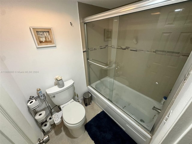 bathroom with enclosed tub / shower combo and toilet