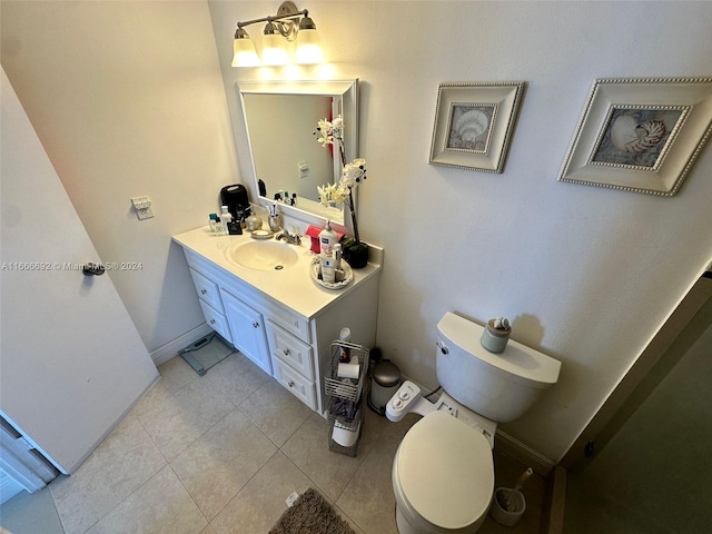 bathroom with vanity, toilet, and tile patterned floors