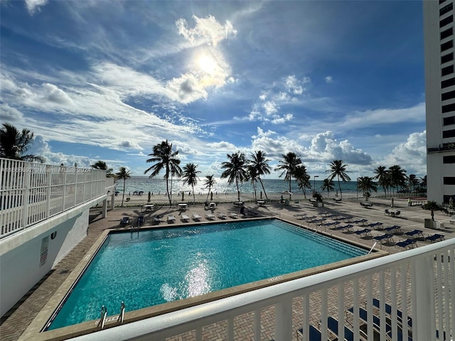 view of swimming pool featuring a water view