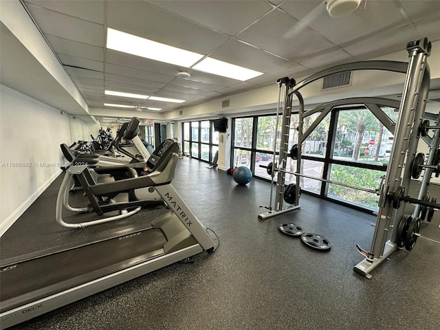 exercise room featuring a drop ceiling