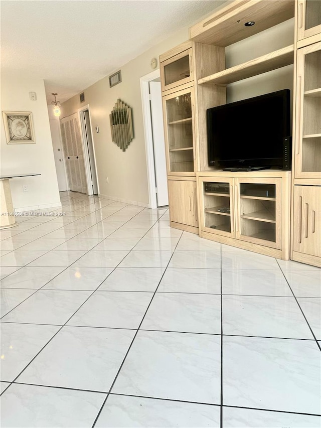 unfurnished living room with light tile patterned floors