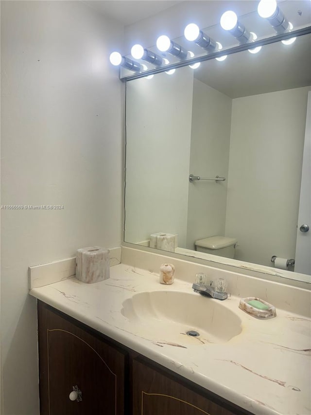 bathroom with vanity and toilet