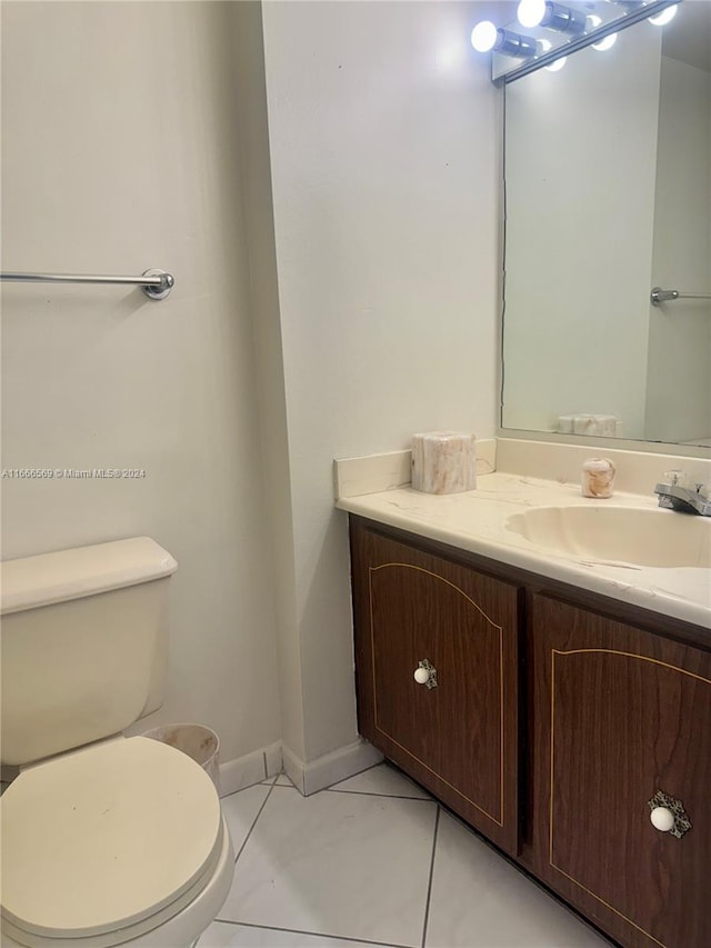 bathroom featuring vanity, toilet, and tile patterned floors