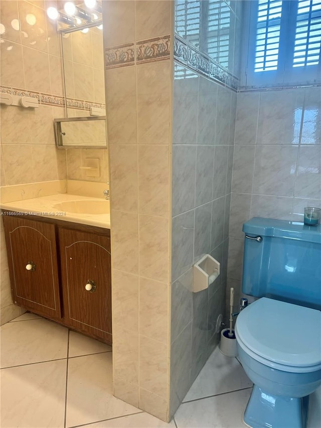 bathroom with vanity, tile walls, toilet, and tile patterned floors