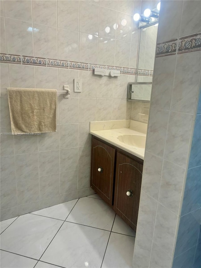 bathroom with vanity, tile walls, and tile patterned floors