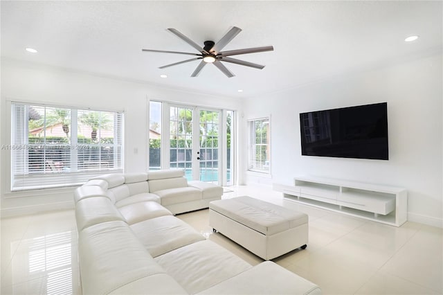 tiled living room featuring ceiling fan, french doors, and crown molding