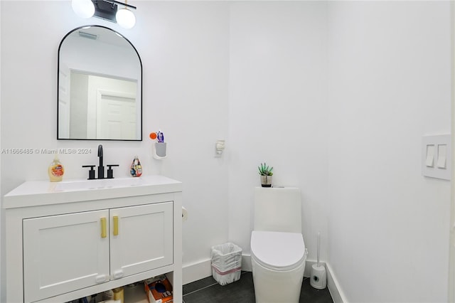 bathroom with tile patterned floors, vanity, and toilet