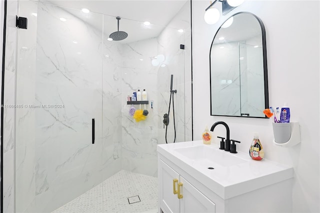 bathroom featuring vanity and a shower with shower door