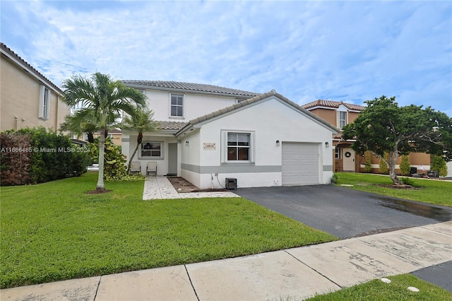 mediterranean / spanish-style house with a front yard and a garage