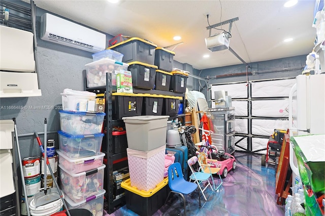 interior space with a garage door opener, a wall unit AC, and white refrigerator