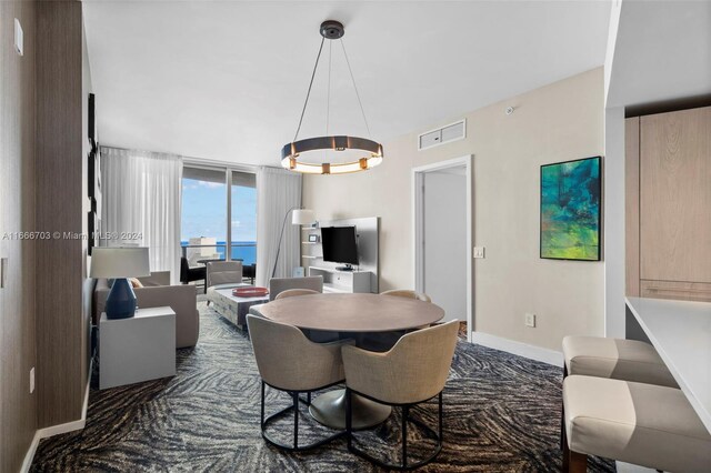 dining space with dark colored carpet