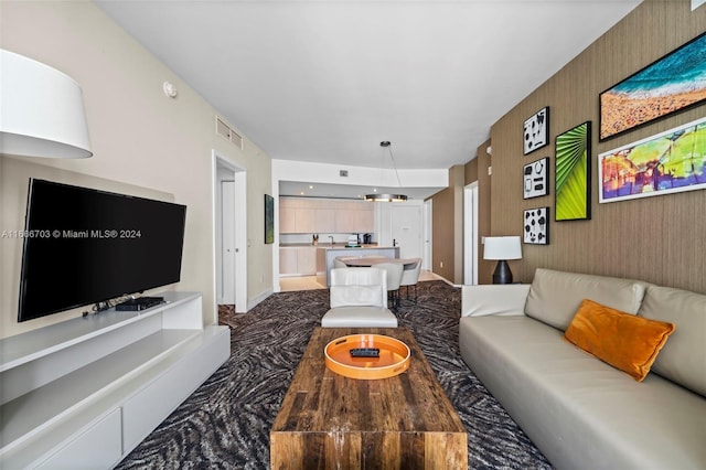 living room with baseboards and visible vents