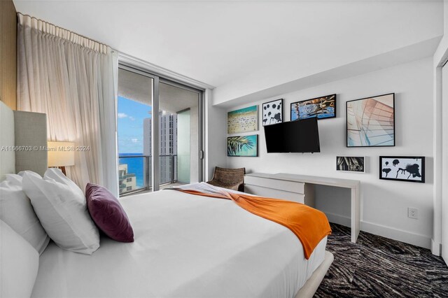 bedroom featuring dark colored carpet and access to exterior