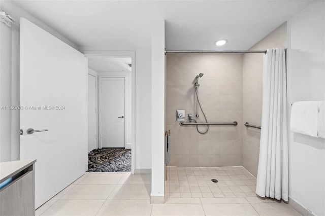 bathroom featuring tile patterned floors, baseboards, a shower stall, and recessed lighting