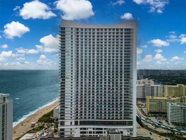 exterior space featuring a water view and a beach view