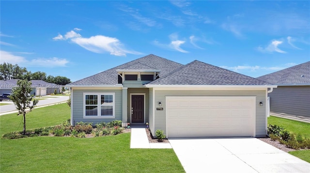 view of front of house with a front lawn and a garage