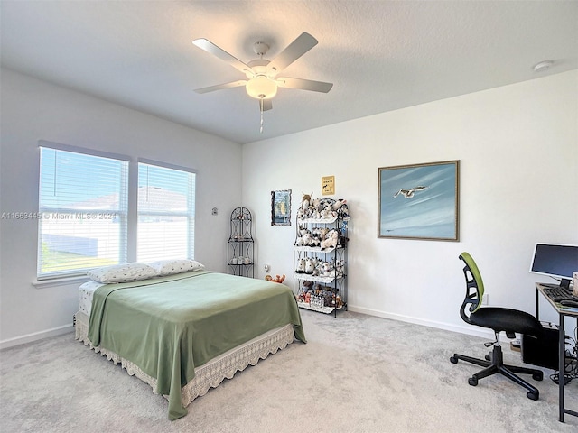 carpeted bedroom featuring a textured ceiling and ceiling fan