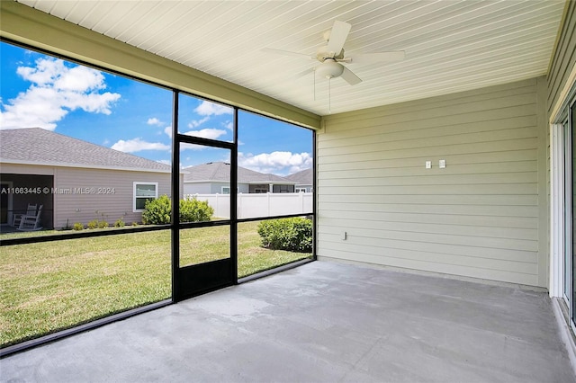 unfurnished sunroom with ceiling fan