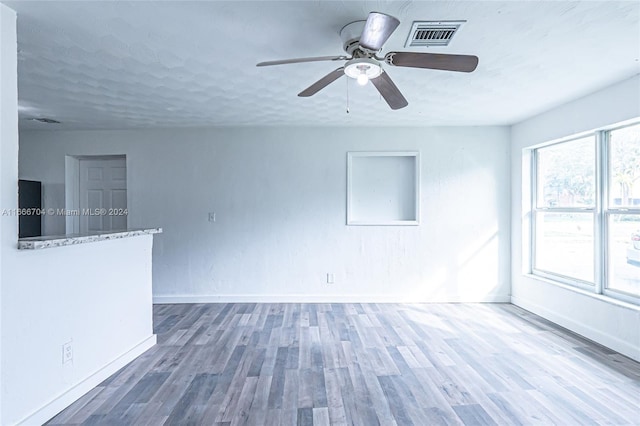 spare room with dark hardwood / wood-style floors and ceiling fan