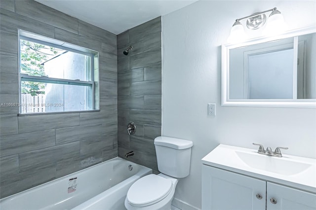 full bathroom with vanity, tiled shower / bath combo, and toilet