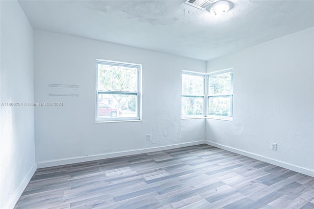 empty room featuring hardwood / wood-style flooring and a healthy amount of sunlight