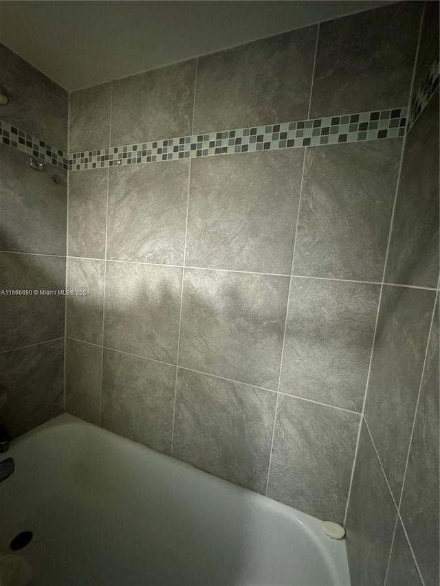 bathroom featuring shower with separate bathtub