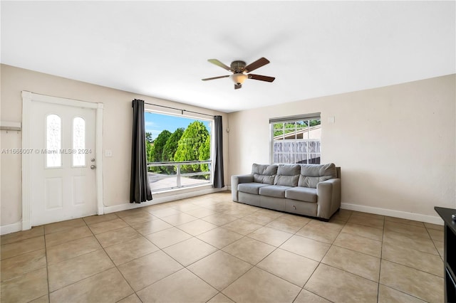 tiled living room featuring a healthy amount of sunlight and ceiling fan