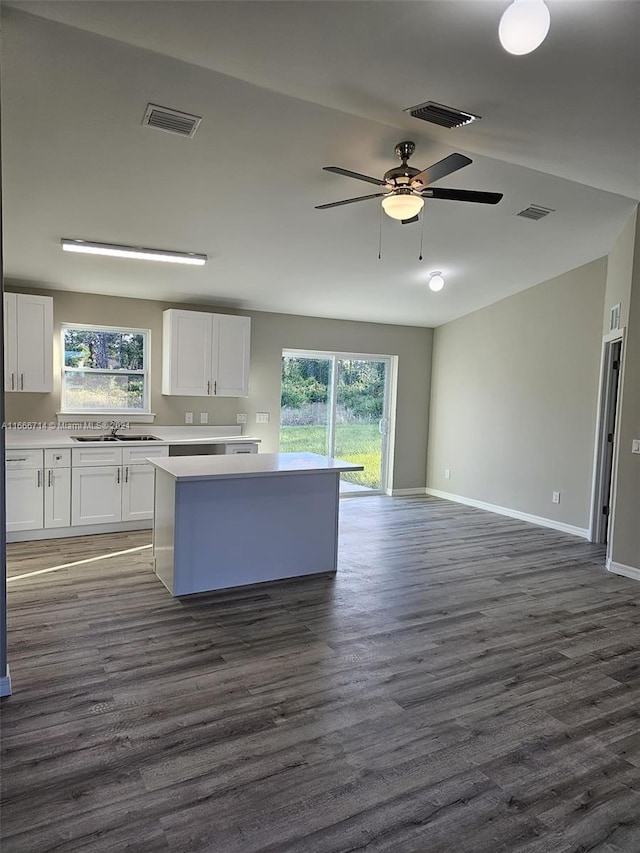 kitchen featuring plenty of natural light, dark wood-type flooring, ceiling fan, and white cabinets