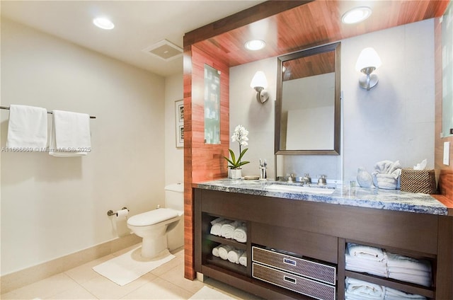 bathroom featuring toilet, vanity, and tile patterned floors