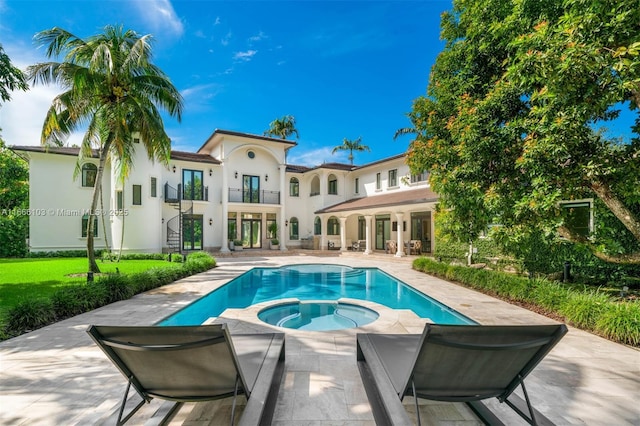 view of pool featuring a patio area and an in ground hot tub