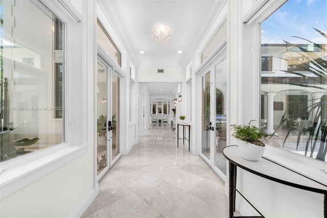 corridor featuring french doors and ornamental molding