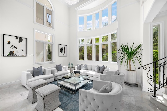 living room with a healthy amount of sunlight and a towering ceiling