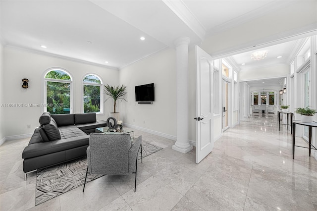 living room with ornate columns, crown molding, and a chandelier