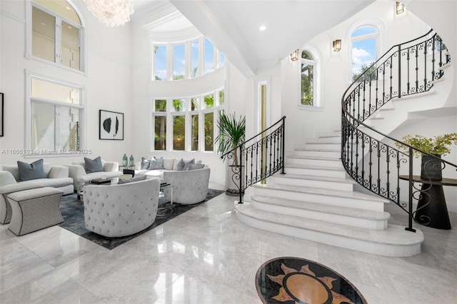 living room with a high ceiling and plenty of natural light