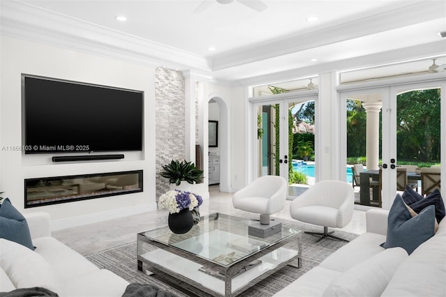 living room with ceiling fan, ornamental molding, and french doors