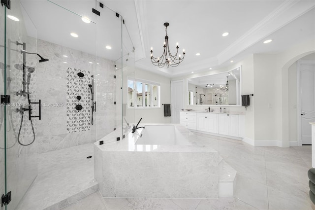 bathroom featuring plus walk in shower, ornamental molding, vanity, and a notable chandelier