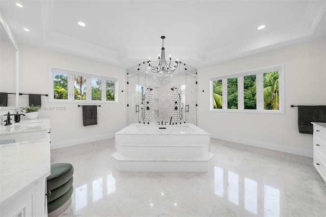 bathroom featuring independent shower and bath, plenty of natural light, a raised ceiling, and vanity