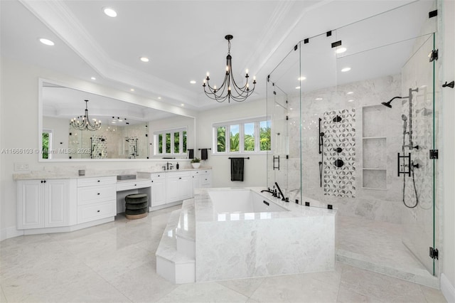 bathroom with plus walk in shower, vanity, a tray ceiling, and an inviting chandelier