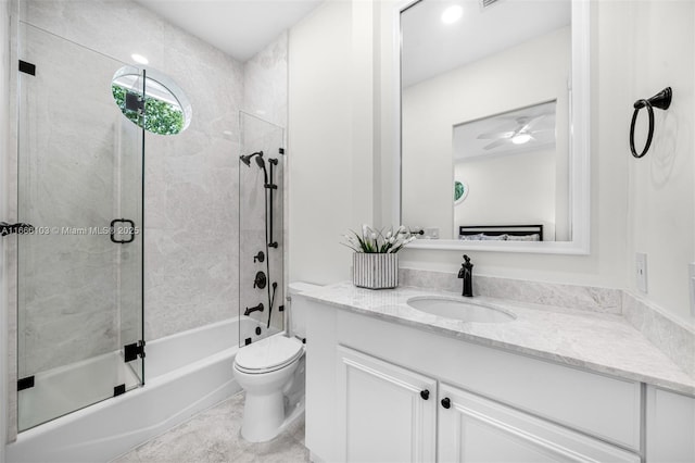 full bathroom with toilet, ceiling fan, combined bath / shower with glass door, and vanity