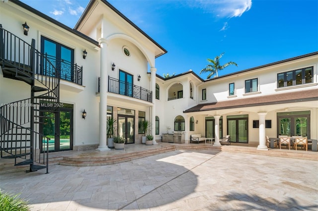 rear view of property featuring french doors and a patio