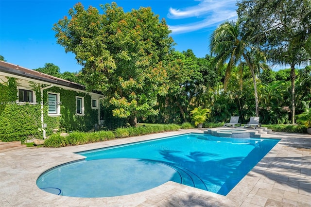 view of swimming pool featuring an in ground hot tub and a patio