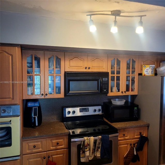 kitchen with stainless steel appliances and track lighting